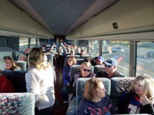 People talk inside a charter bus