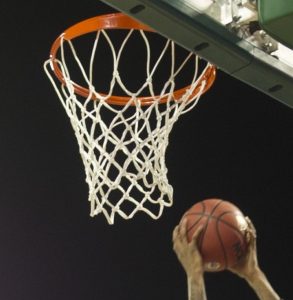 Hands and basketball near basketball net